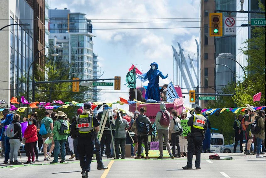  Several dozen supporters of the environmental group Extinction Rebellion occupy the intersection of Granville and Georgia streets in Vancouver, Saturday, May 1, 2021.