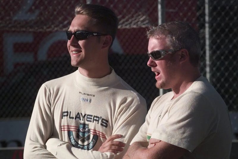 Canadian Indy car drivers Greg Moore, left, and Paul Tracy chat while waiting to go out for 1998 Indy practice on race day morning. Ward Perrin photo - POSTMEDIA