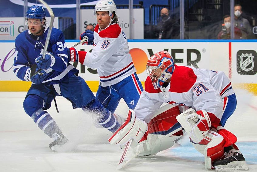 Habs defenceman Ben Chiarot battles Leafs' Auston Matthews in front of goaltender Carey Price Thursday night in Toronto. Price made 35 saves to lead Montreal to a 2-1 win in Game 1 of the series.