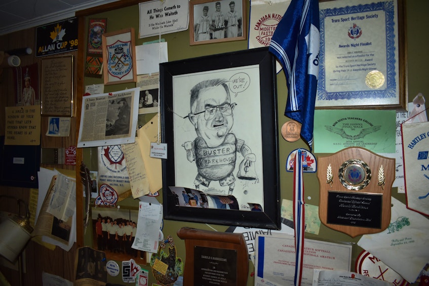 A wall of personal sports memorabilia and awards Harold Barkhouse has collected from his time as an official in both hockey and fast-pitch softball. - Richard MacKenzie