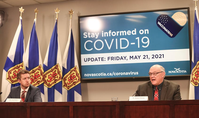 Nova Scotia Premier Iain Rankin and Dr. Robert Strang, chief medical officer of health, hold a COVID-19 briefing in Halifax on May 21, 2021. They're wearing Cape Breton tartan ties sent to them by the Savoy Theatre in Glace Bay along with similarly themed face masks.  - Communications Nova Scotia