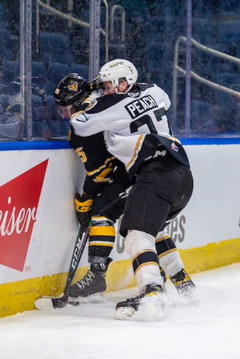 Charlottetown Islanders winger Bailey Peach, right, hits Victoriaville Tigres defenceman Jeremy Michaud during Game 3 of the Quebec Major Junior Hockey League semifinal Friday in Quebec City. - Jonathan Roy - QMJHL
