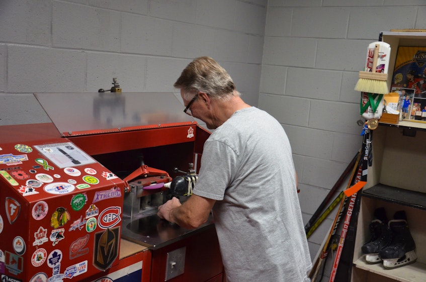Blaine (Alfie) Gallant sharpens a pair of skates at Credit Union Place in Summerside. - Jason Simmonds