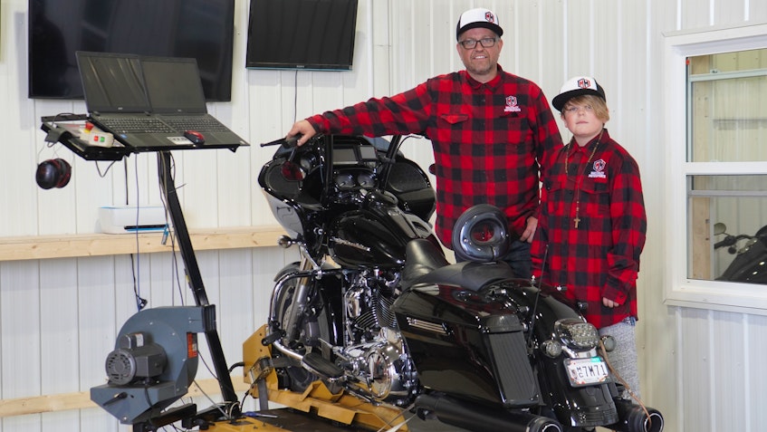 Jeff MacKinley, left, and his son Corbin showcase their high-end motorcycle tuning meter at MacKinley Motorsports in Cornwall. - Daniel Brown