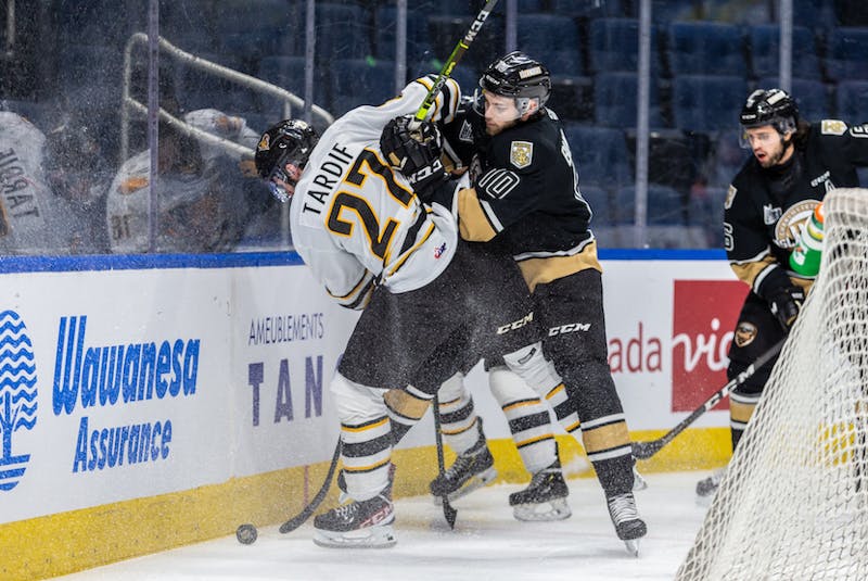 Charlottetown Islanders captain Brett Budgell, right, hits Victoriaville Tigres forward Benjamin Tardif during Tuesday's Game 5 of the best-of-five Quebec Major Junior Hockey League semifinal in Quebec City. – Jonathan Roy - QMJHL