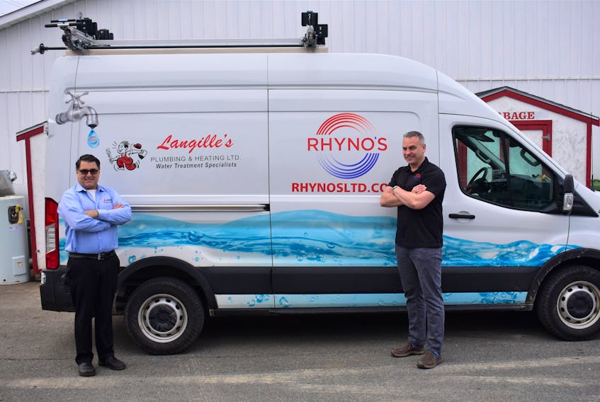 Jayme Rhyno (right) of Rhyno’s Heating, Ventilation, Air Conditioning & Refrigeration celebrates one year of merging businesses with Paul Langille (left) from Langille’s Plumbing & Heating Limited. - Photo Contributed.