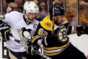 Sidney Crosby, left, and Brad Marchand fight for the puck during a 2016 NHL game. - NHL