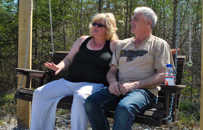 Shavonne Wickens and Doug Wessel spend a few minutes relaxing on the swing set that is part of the outdoor oasis at the 80‘s Rewind pubcade in East Pubnico. KATHY JOHNSON 