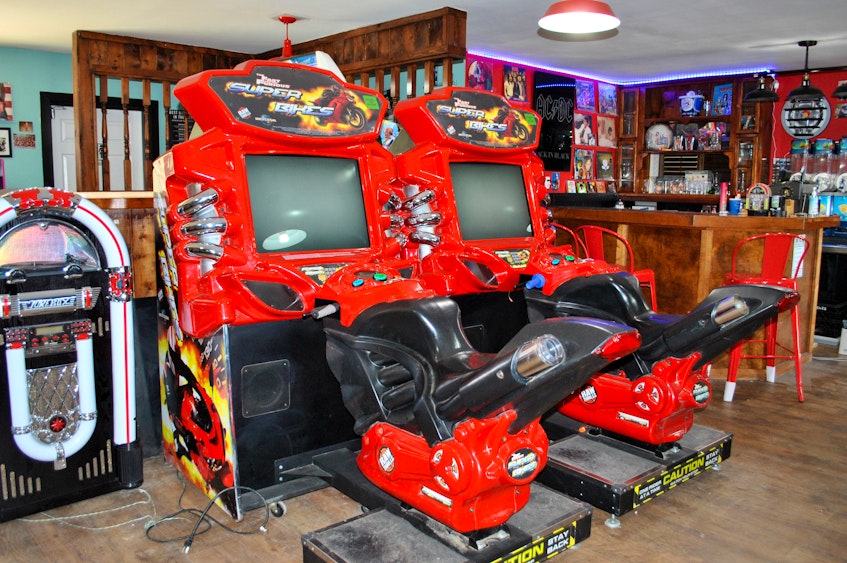 Two racing machines are among the arcade games at the 80‘s Rewind pubcade in East Pubnico. KATHY JOHNSON 