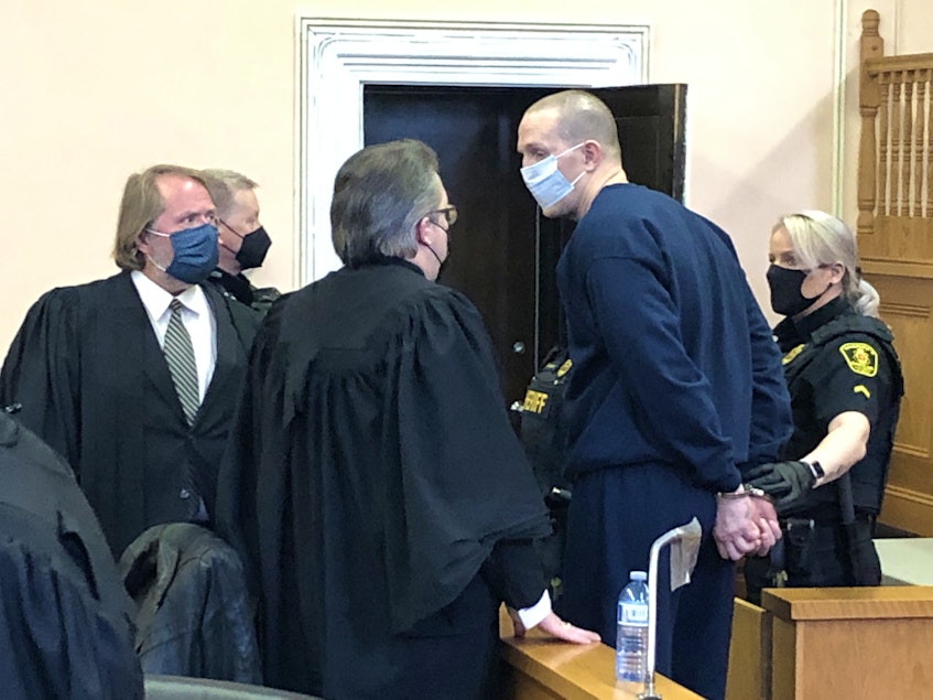 Paul Connolly speaks with his defence lawyers, Mark Gruchy (centre) and Jeff Brace, in Newfoundland and Labrador Supreme Court in St. John's Wednesday before a sheriff escorts him back to the lockup. - Tara Bradbury