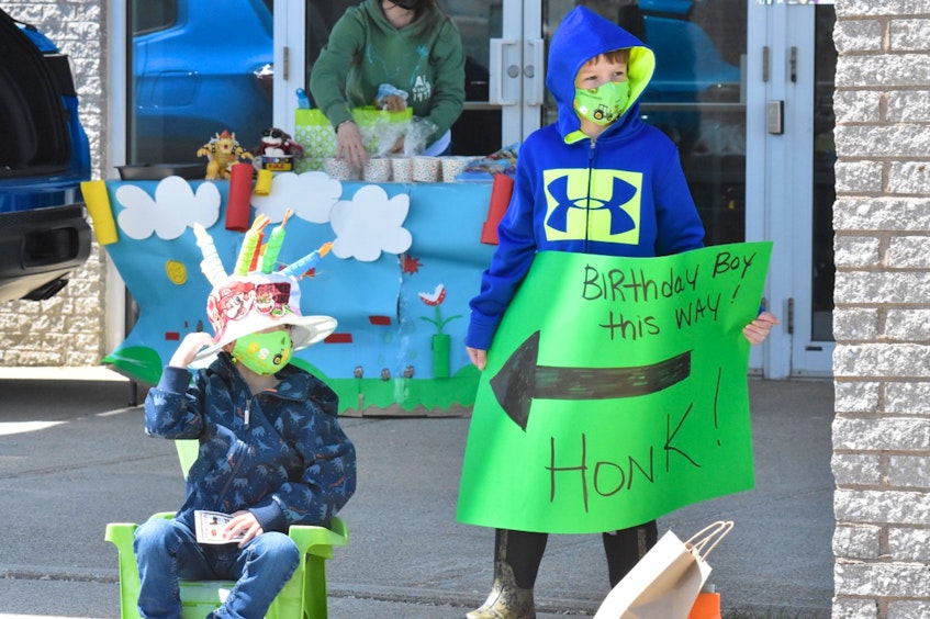 Ben getting some extra birthday love from older brother Landyn during his recent birthday parade. TINA COMEAU PHOTO 