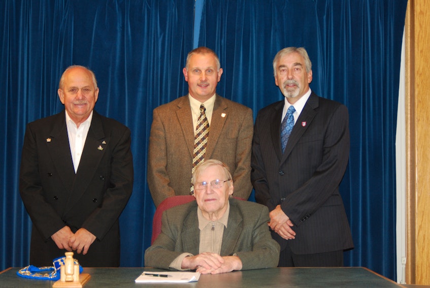 Philip Wood officially became the mayor of Bay Roberts following Glenn Littlejohn's successful bid in 2011 to enter provincial politics. Pictured at an October 2011 council meeting where Littlejohn formally resigned as mayor are, from the left, concil member Bill Seymour (who became the new deputy mayor), Littlejohn and Wood. Seated is former Bay Roberts mayor Eric Dawe, who died in 2015. - File Photo