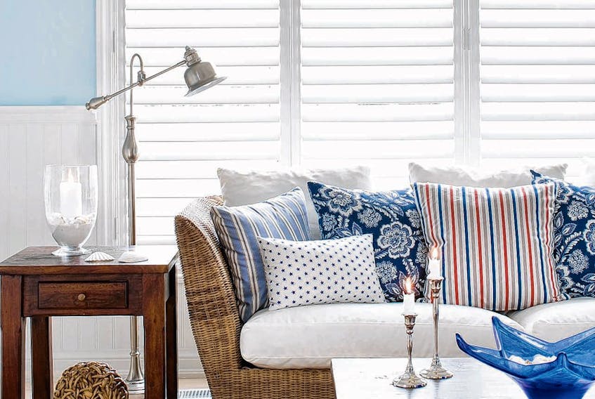 Colin and Justin created this beachy, summery vibe using a textural floor rug, wall panelling, layers of rattan and sky-blue paint by Benjamin Moore.