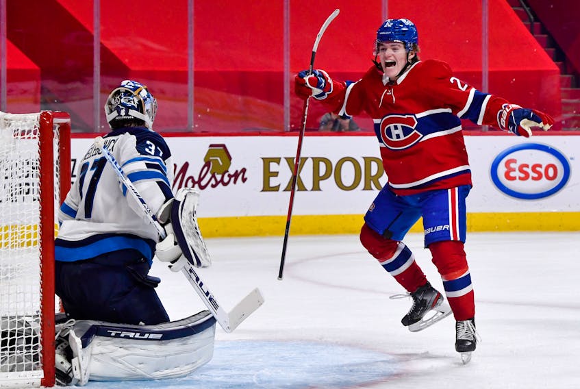 Montreal Canadiens’  Cole Caufield  celebrates a goal by teammate Artturi Lehkonen against Winnipeg Jets goalie Connor Hellebuyck during an NHL game on May 1.  Eric Bolte-USA TODAY Sports