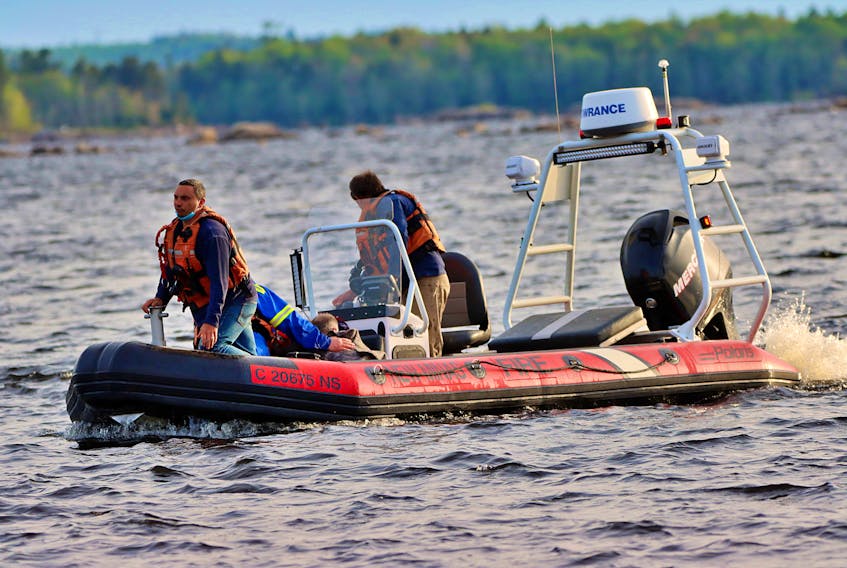 Firefighters from Kentville and New Minas teamed up to rescue two paddlers after a canoe overturned on Gaspereau Lake Friday evening. – Adrian Johnstone 