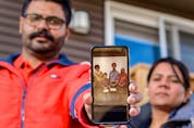  Gurbhajan Dhillon holds a photo of his parents Harbans and Sukhdev Dhillon and their grandkids in his phone while his wife Rajvir Dhillon stands beside him on Sunday, May 2, 2021. Harbans and Sukhdev Dhillon are unable to fly back to Canada from India because of the travel ban.