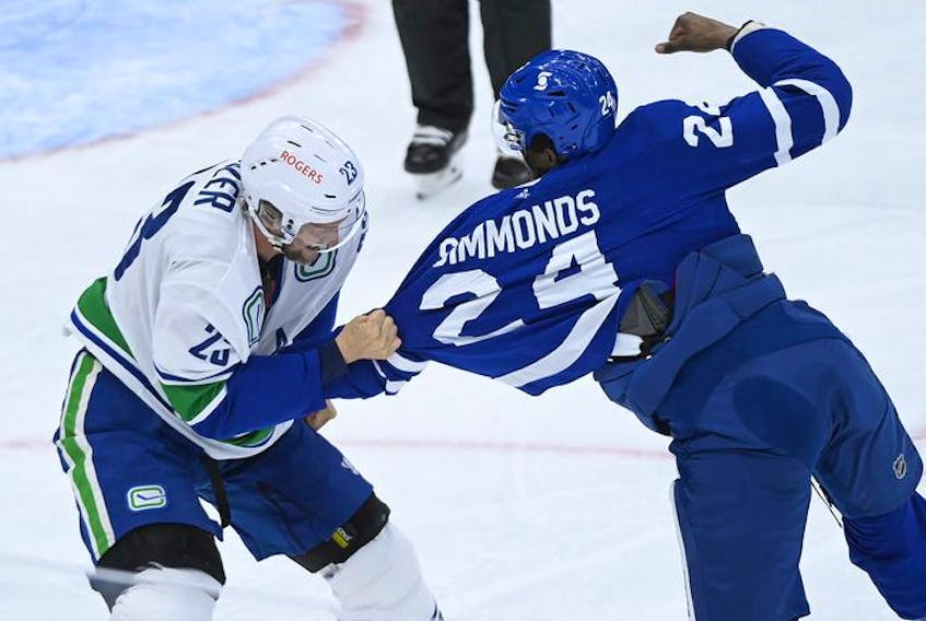  Toronto Maple Leafs forward Wayne Simmonds (24) fights Vancouver Canucks defenceman Alexander Edler (23) during first period NHL hockey action in Toronto on Thursday, April 29, 2021.