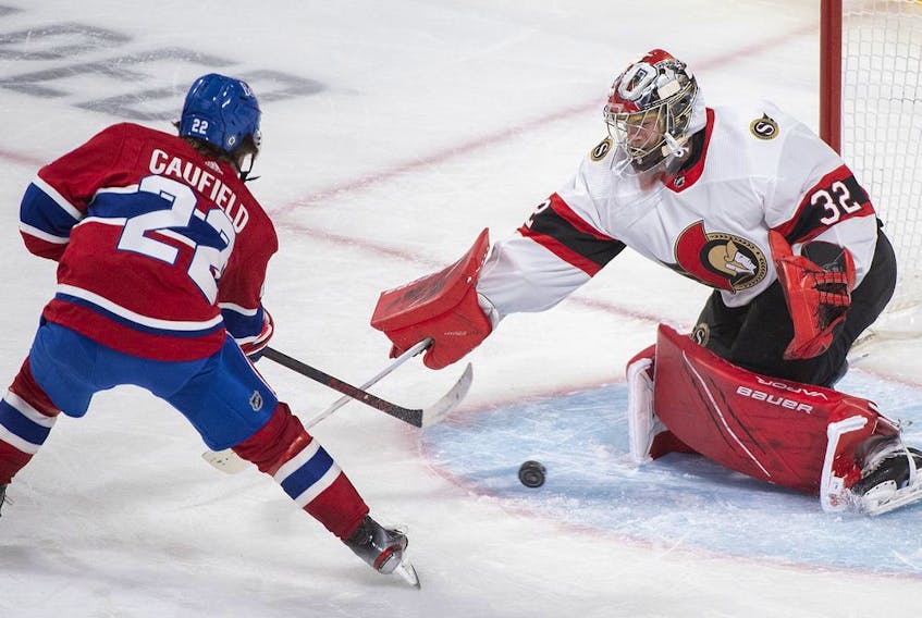 Montreal Canadiens' Cole Caufield moves in on Ottawa Senators goaltender Filip Gustavsson during second period NHL hockey action in Montreal, Saturday, May 1, 2021.