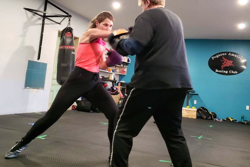 Erin Tardif-Woolgar is shown working out with her coach and trainer, Bruce Harkness of the Pegasus Boxing Club in Middleton. - Contributed