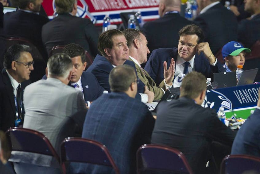 Jim Benning, Francesco Aquilini and some of the Vancouver Canucks' scouting staff at the 2019 NHL Entry Draft in Vancouver.