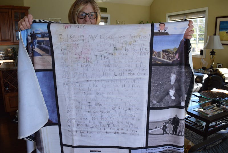 Williams holds a fleece blanket made of old photos of her grandson, as well as a note written by Kylar. - Alison Jenkins