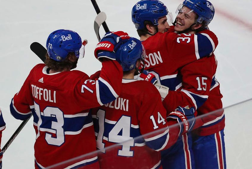 Montreal Canadiens' Jesperi Kotkaniemi (15) celebrates his game winning goal with teammates Tyler Toffoli, Nick Suzuki and Erik Gustafsson during overtime in Game 6 in Montreal on May 29, 2021. 