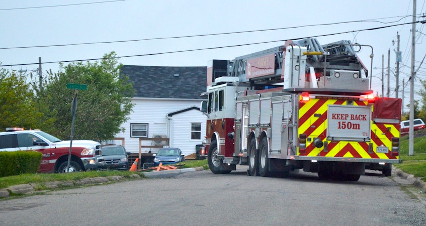 Firefighters block off a section of Bison Drive at Seaview Street in Whitney Pier Monday as they battled a structure fire up the road. No injuries were reported. CAPE BRETON POST PHOTO. - SaltWire Network