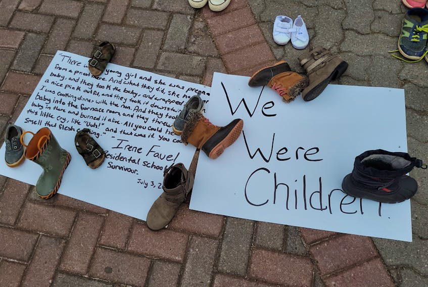 Signs were also placed near the Macdonald statue, some with the words of residential school survivors. 