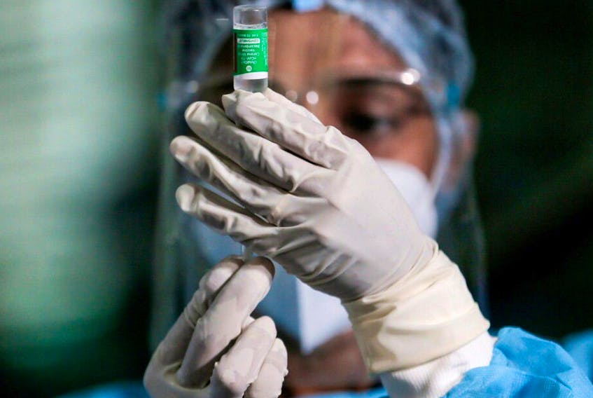 A health official draws a dose of the AstraZeneca's COVID-19 vaccine.