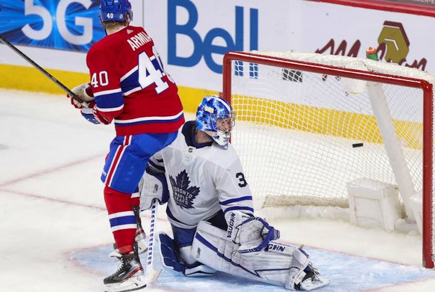 Joel Armia and Leafs goalie Jack Campbell look back at the puck after Habs Cole Caufiled scored game-winning goal during overtime in Montreal on Monday, May 3, 2021.