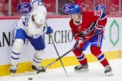 Cole Caulfield battles for the puck with Toronto Maple Leafs' Timothy Liljegren during first-period action in Montreal on Monday May 3, 2021.