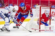 Goalie Jake Allen watches as defenceman Ben Chiarot pokes the puck away from Toronto Maple Leafs' Alexander Kerfoot during second-period action in Montreal on Monday May 3, 2021.