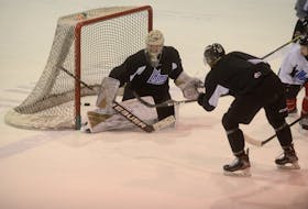Goalie Colten Ellis prepares to make a blocker save on Brendan McCarthy during Tuesday’s Charlottetown Islanders practice at the Eastlink Centre.
