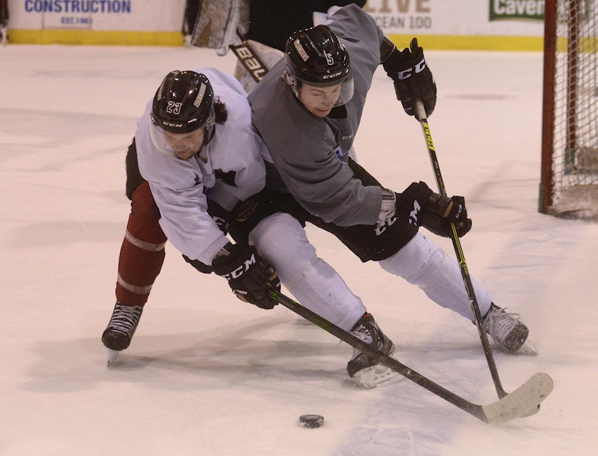 Charlottetown Islanders forward Zac Beauregard, left, and defenceman Braeden Virtue battle for the puck during Tuesday’s practice at the Eastlink Centre. - Jason Malloy • The Guardian
