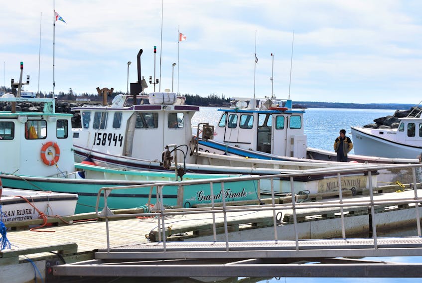 There wasn’t a lot of activity at the Cape John Wharf a day before setting day, originally scheduled for April 30, but a few lobster fishermen were around, including Keith Heighton on his boat Risky Business. 