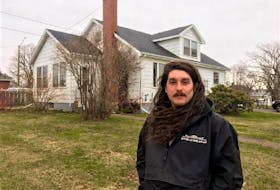 Tyler Leamont, 31, stands in front of the four-bedroom residence on Spring Park Road he moved into last October. The neighbourhood was rezoned in 2019 and the house is set to be demolished this June. Leamont and his two roommates were given three months to vacate it. 
