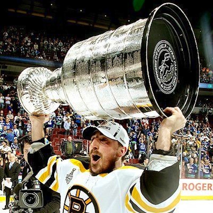Brad Marchand raises the Stanley Cup in 2011. - Contributed
