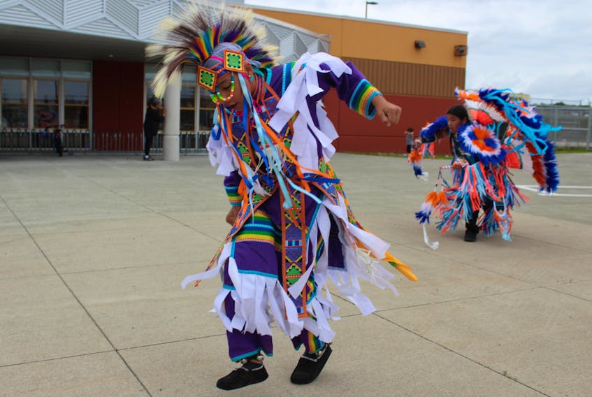 Liddell Sylliboy and Karzen Toney, both of Eskasoni First Nation, dance outside Maupeltuewey Kina'matno'kuom, the school in Membertou First Nation in 2019. The school is part of the Mi'kmaw Kina'matnewey, the organization that oversees Mi'kmaq education in Nova Scotia and a recipient of this year's Governor General's Innovation Award. FILE 