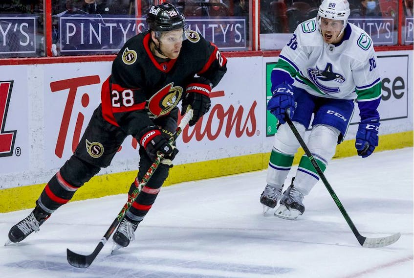 Ottawa Senators right wing Connor Brown eludes the check of Vancouver Canucks defenceman Nate Schmidt.