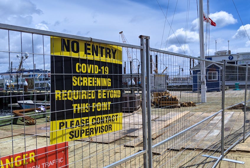 A sign warns of COVID-19 restrictions on the Halifax waterfront in May 2021.