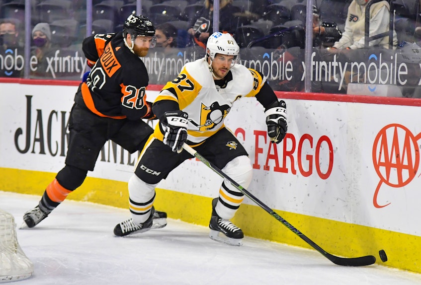 Pittsburgh Penguins centre Sidney Crosby and Philadelphia Flyers centre Claude Giroux battle for the puck during Monday's NHL game at Philadelphia's Wells Fargo Center. - Eric  Hartline