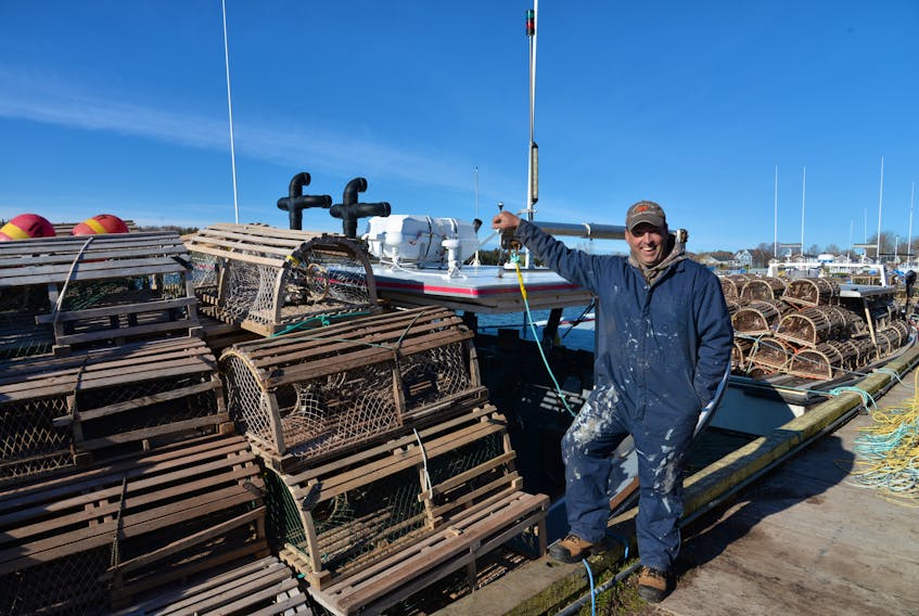 Blake Buote stands next to his boat - The Bella Marie - before leaving the North Rustico Harbour for the open water on Tuesday for the start of spring lobster season to set lobster traps.