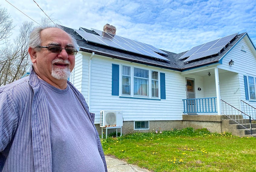Don Deveau stands in front of his home in Yarmouth, which features 14 solar panels. CARLA ALLEN • TRICOUNTY VANGUARD