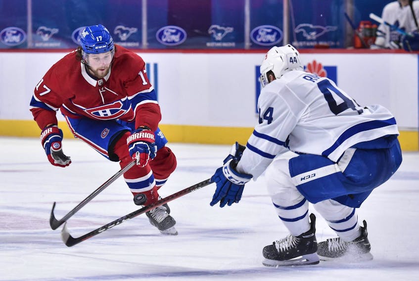 Josh Anderson of the Montreal Canadiens, left, and Morgan Rielly of the Toronto Maple Leafs skate after the puck during the third period at the Bell Centre on May 3, 2021 in Montreal.