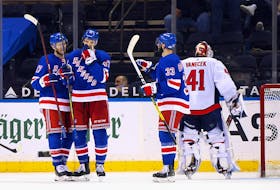 Morgan Barron of the New York Rangers, centre, celebrates his first NHL goal against the Washington Capitals at Madison Square Garden on Wednesday.