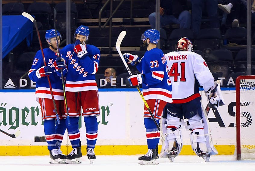 Morgan Barron of the New York Rangers, centre, celebrates his first NHL goal against the Washington Capitals at Madison Square Garden on Wednesday.