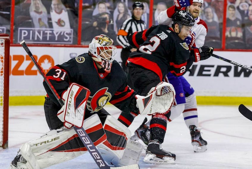 Ottawa Senators goaltender Anton Forsberg (31) follows the play as defenceman Artem Zub (2) battles with Montreal Canadiens right wing Joel Armia (40) during the second period.