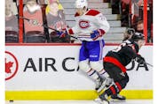 Ottawa Senators defenceman Erik Brannstrom (26) checks Montreal Canadiens centre Jake Evans (71) during the second period.