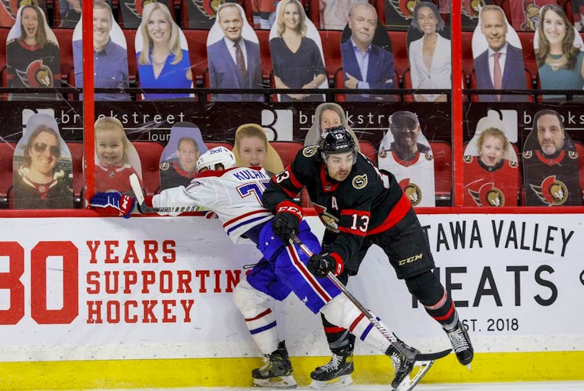 Ottawa Senators left wing Nick Paul (13) wins a puck battle against Montreal Canadiens defenceman Brett Kulak.