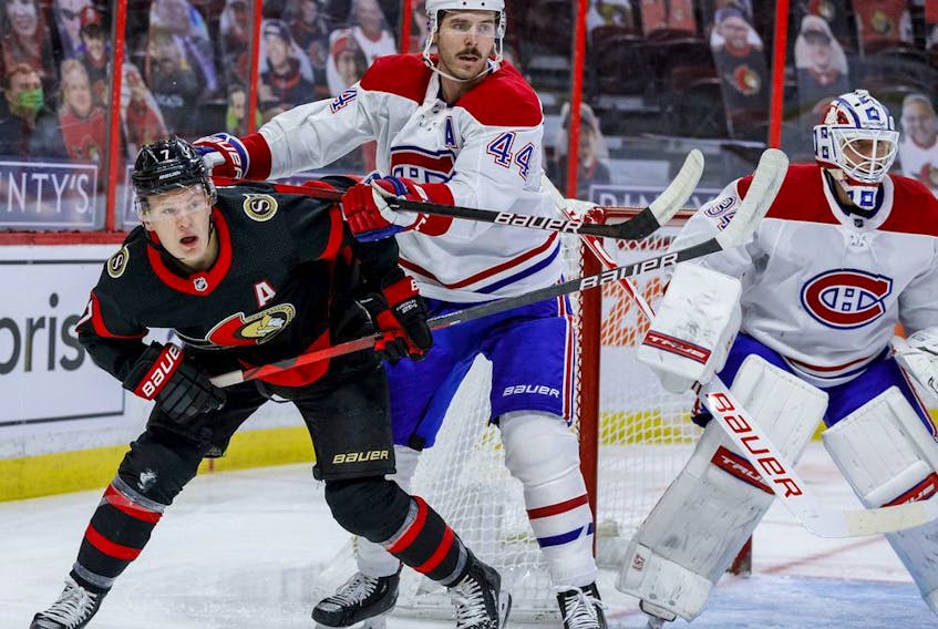 Ottawa Senators left wing Brady Tkachuk (7) battles with Montreal Canadiens defenceman Joel Edmundson (44) beside goaltender Jake Allen (34) during the first period.